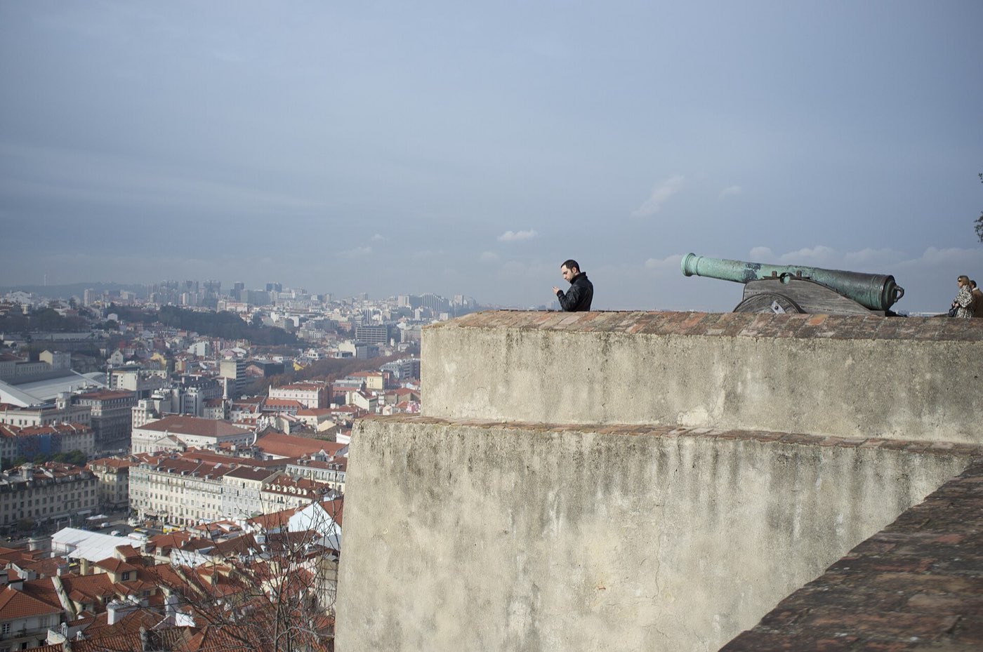 The stone walls and towers of São Jorge Castle on the hill above Lisbon