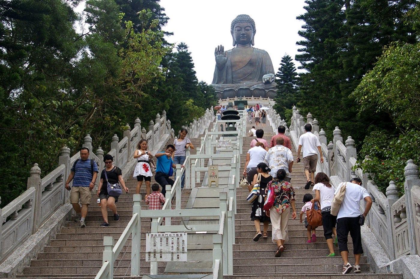 Crowds climbing the long staircase up to the bronze Tian Tan Buddha statue on Lantau Island, seen from below
