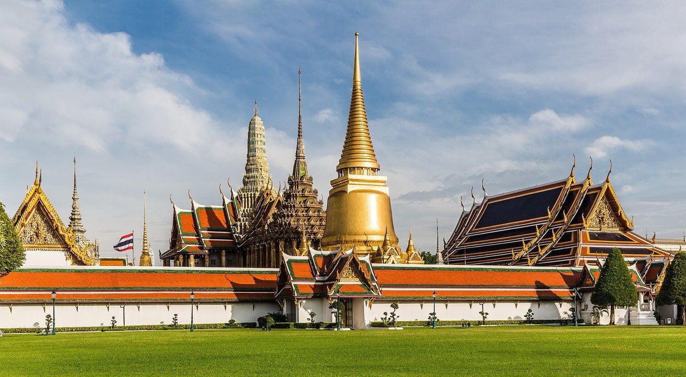 The golden chedi and tiered orange roofs of Wat Phra Kaew inside the Grand Palace complex